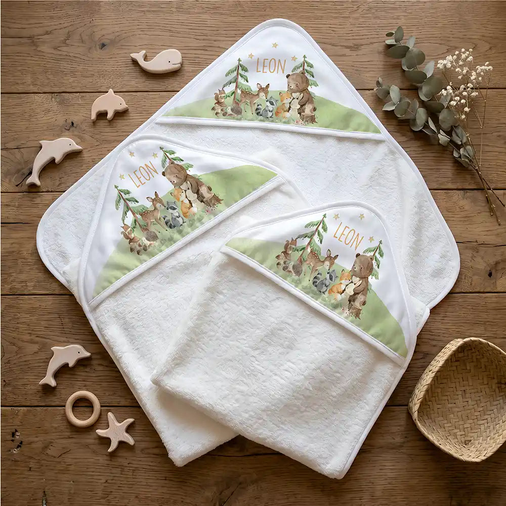 Personalisiertes Kapuzenhandtuch Baby Waldfest – Flatlay mit Eukalyptus und Beißring